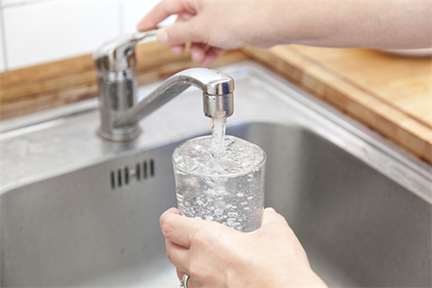 Water  Fees & Charges - Fulling up a glass of water from the tap.
