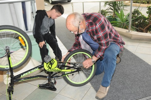 Monthly Repair Cafe.- Kids bike being fixed.
