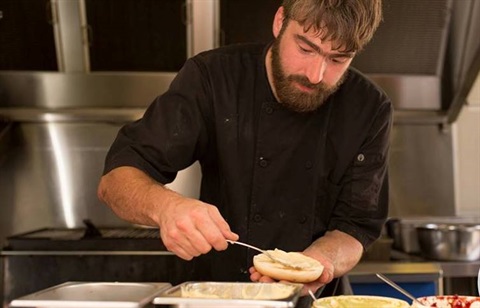 Mobile Food Businesses - Man making a burger in a mobile food business - Dutchies.