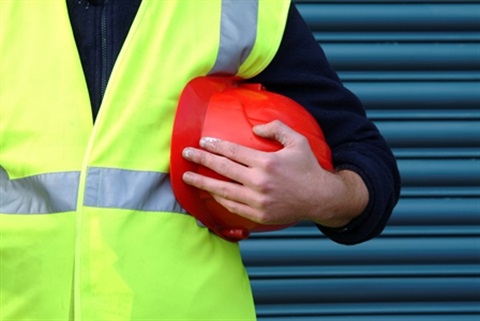 Traffic Management - Man in hi vis vest holding a red hard hat.