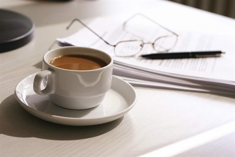 Opening a food business - Coffee, paper and pen on a desk.